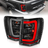 ANZO 311394 FITS: 1999-2004 Jeep Grand Cherokee LED Tail Lights w/ Light Bar Black Housing Clear Lens Tail Lights