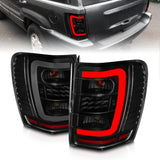 ANZO 311395 FITS: 1999-2004 Jeep Grand Cherokee LED Tail Lights w/ Light Bar Black Housing Smoke Lens Tail Lights