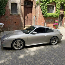 Load image into Gallery viewer, Silver Porsche 996.2 front lip and ducktail spoiler made of polyurethane, installed on a 2002–2004 model for aerodynamic upgrade.