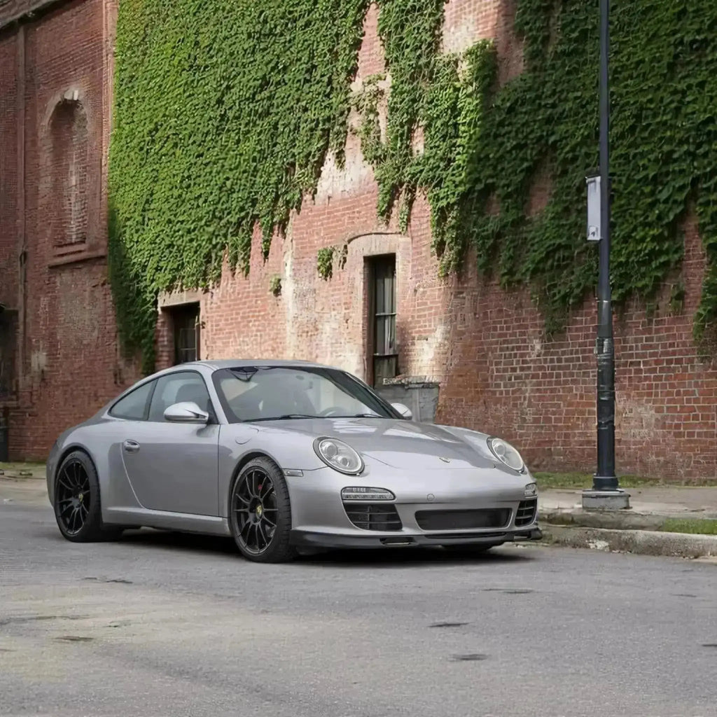 Silver Porsche 997.2 Aero Kit front lip and side rockers by BetterBodies Motorsport for 2009-2012 models.