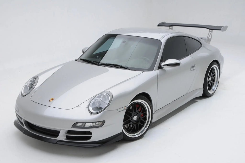 BetterBodies Motorsport Porsche 997 Carrera narrow body side rockers and polyurethane aero skirts installed on a 2005–2011 model.