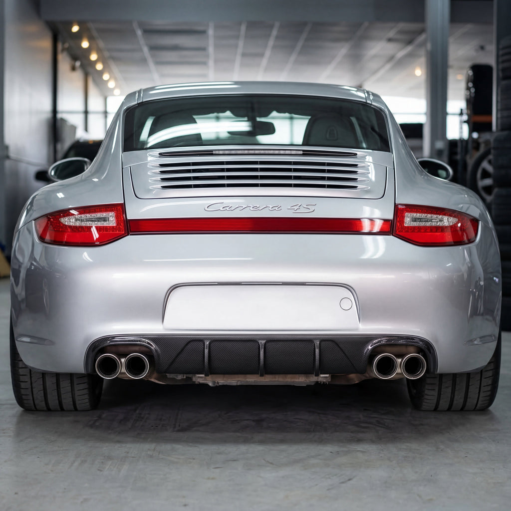 Silver Porsche 997.2 rear bumper diffuser in RUF/TA style, made of polyurethane, installed on a 2009–2012 sports car.